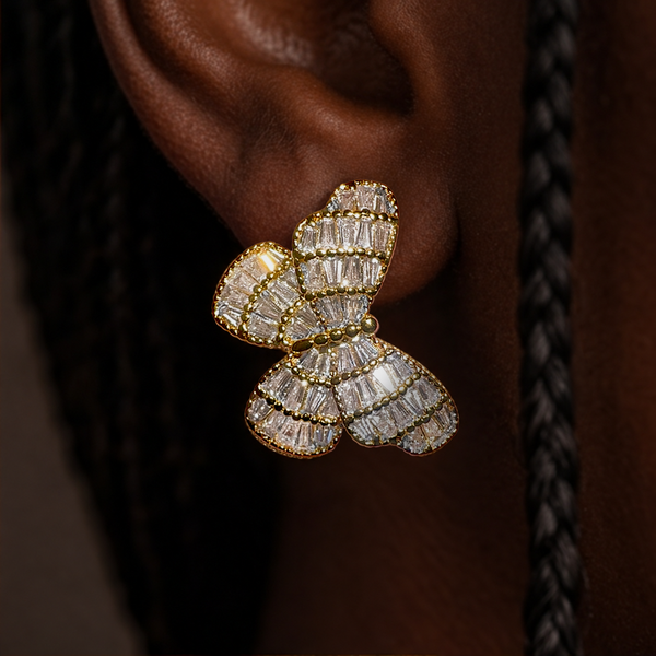 Heirloom Crystal Butterfly earring worn on the ear, gold butterfly with rows of crystals, close-up