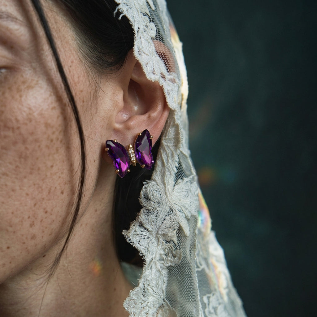 Aurora Crystal Butterfly earring worn on the ear, purple crystal wings, with a cream lace veil