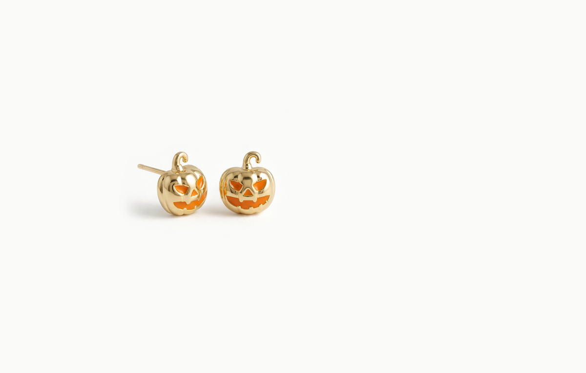 Gold jack-o'-lantern pumpkin stud earrings with an orange face