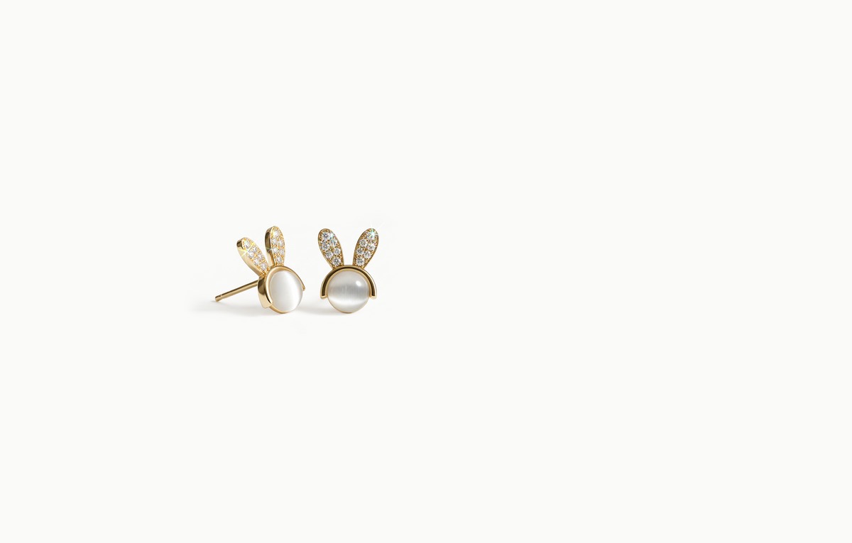 Mini gold stud earrings with a white centre and crystal bunny ears