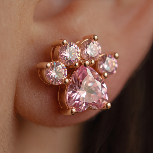 Pink Panther stud earrings, side-angle macro of a pink crystal paw on the ear