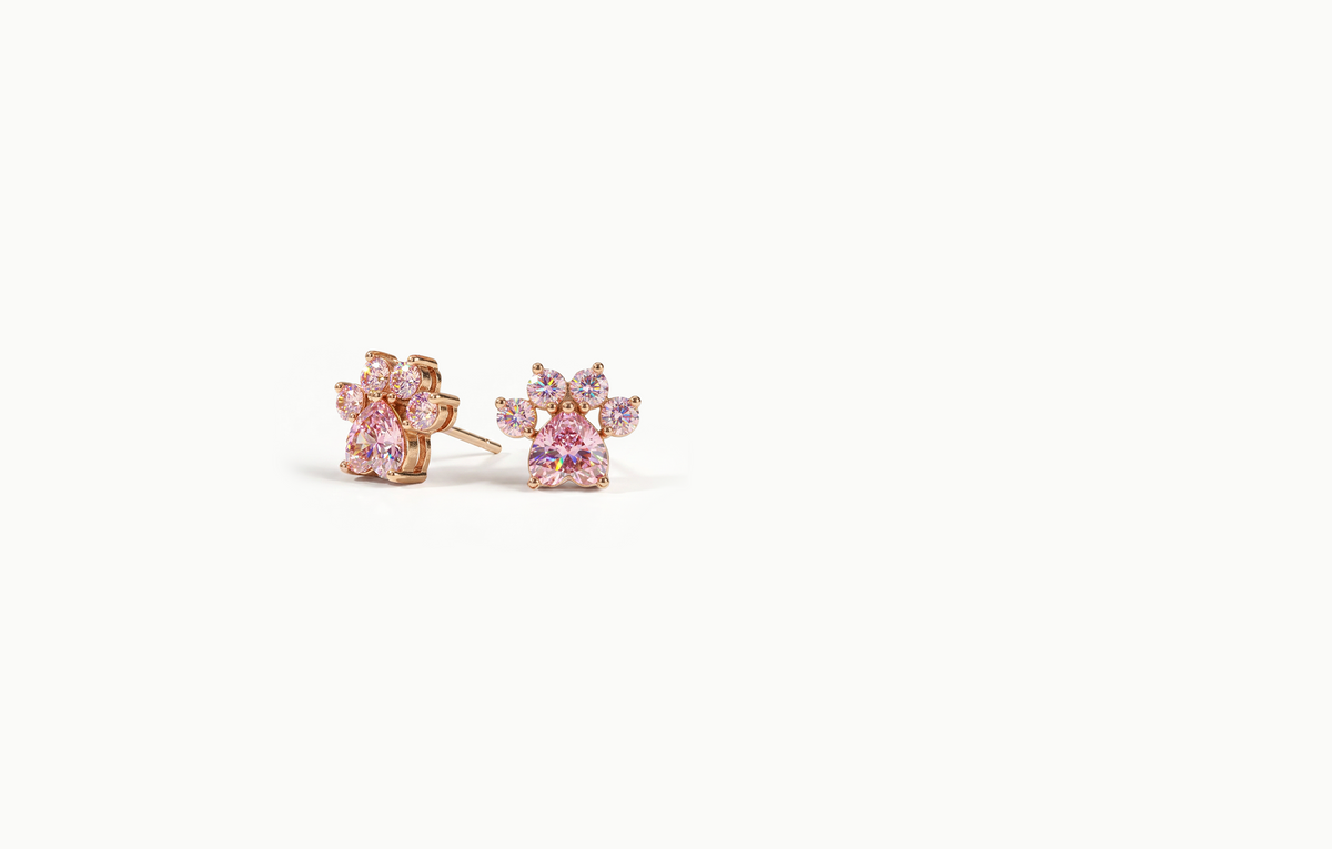 Rose gold paw print stud earrings made of pink crystals
