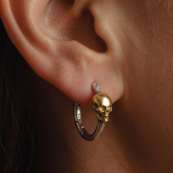 Skeleton Hoop earrings, gold skull on a silver hoop worn on the ear, side angle with the hoop hanging below