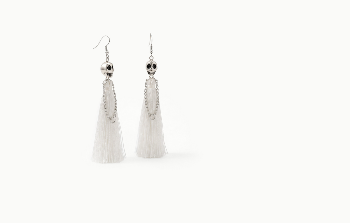 Skull drop earrings with a long white fringe