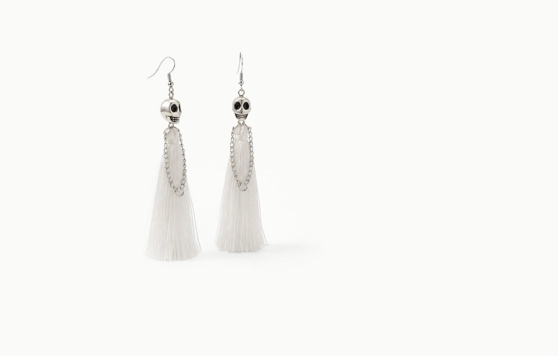 Skull drop earrings with a long white fringe